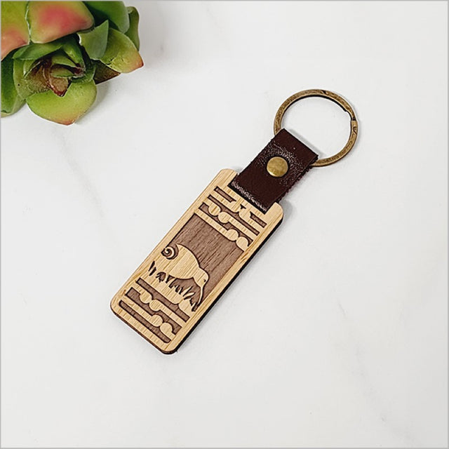 Bamboo keyring with Kiwi and Koru design, eco-friendly and lightweight, perfect for Kiwiana enthusiasts.