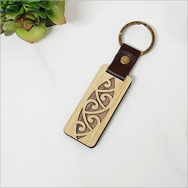 Eco-friendly bamboo keyring featuring unique laser cuts, combining style and sustainability for key organization.