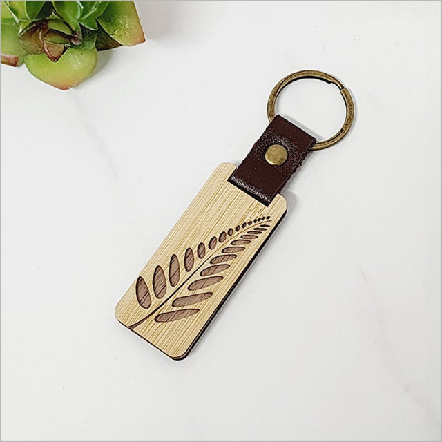 Bamboo keyring featuring a solid fern design, eco-friendly, lightweight, and perfect for stylish key storage.