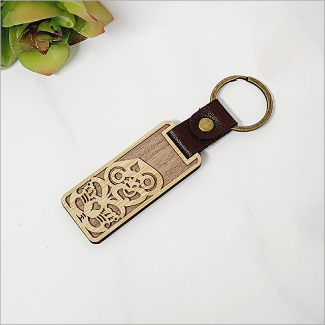 Bamboo keyring featuring a Tiki design, eco-friendly and lightweight, perfect for showcasing Kiwiana charm.
