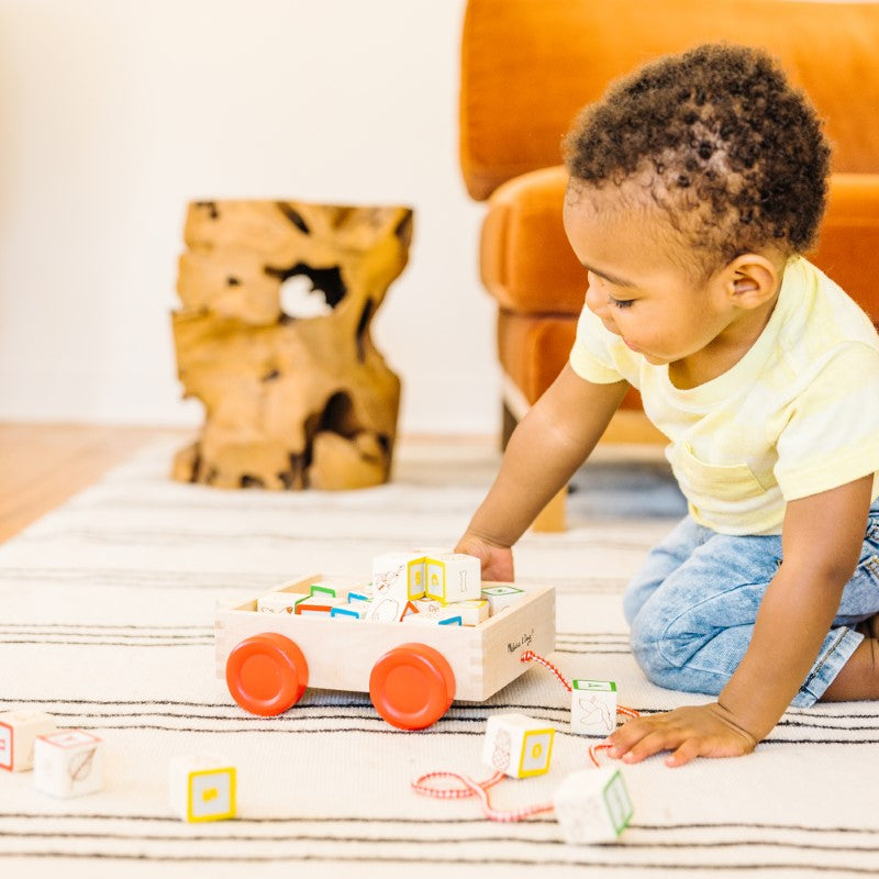 Colorful wooden block cart with 30 letters, numbers, and pictures for toddlers, promoting learning and motor skills development.