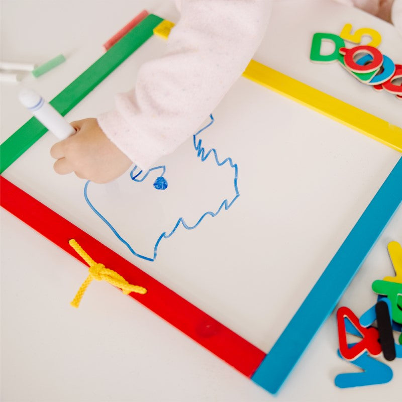 Dual-sided Melissa & Doug board features a dry-erase surface and magnetic chalkboard for creative learning fun.