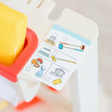 Kid-sized cleaning play set with wooden broom, duster, mop, and accessories for imaginative chore-play fun.