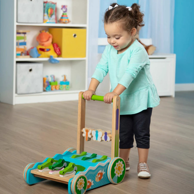 Colorful wooden walker with chomping alligators, engaging beads, and non-skid wheels for toddler development and fun.