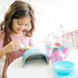 Playful nail care set for kids by Melissa & Doug, featuring tools, polish bottles, and a pretend nail dryer for creative fun.