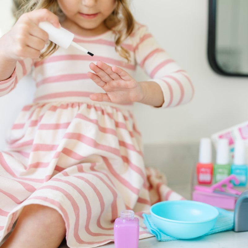 Colorful 20-piece nail care play set for kids, featuring realistic tools and mess-free polish bottles for imaginative play.