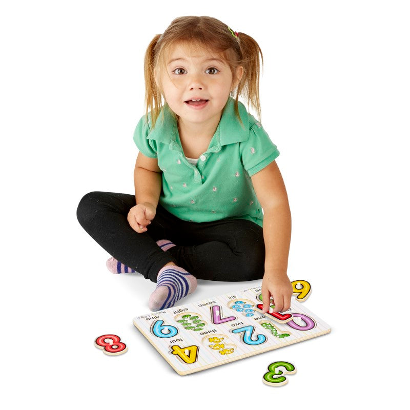 Colorful Melissa & Doug peg puzzle featuring 10 pieces, teaching number concepts 0-9 with engaging illustrations underneath.