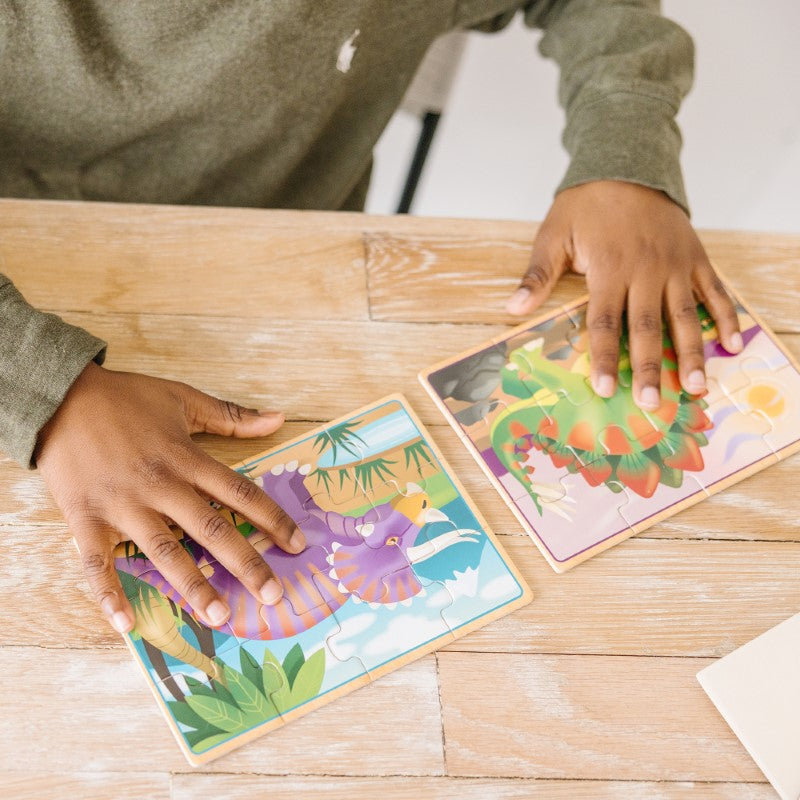 Colorful wooden dinosaur jigsaw puzzles in a box, promoting problem-solving skills for kids aged 3 and up.