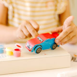 Wooden race car craft kit for kids to build, paint, and decorate; includes axles, wheels, paint, and stickers for personalization.