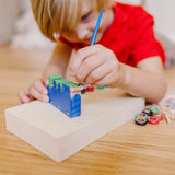 Colorful wooden train craft kit with paint, stickers, and glue for kids to create and personalize their own toy train.