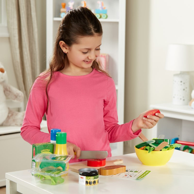 Colorful 52-piece Slice & Toss Salad Set with felt greens, wooden veggies, and salad utensils for imaginative play.