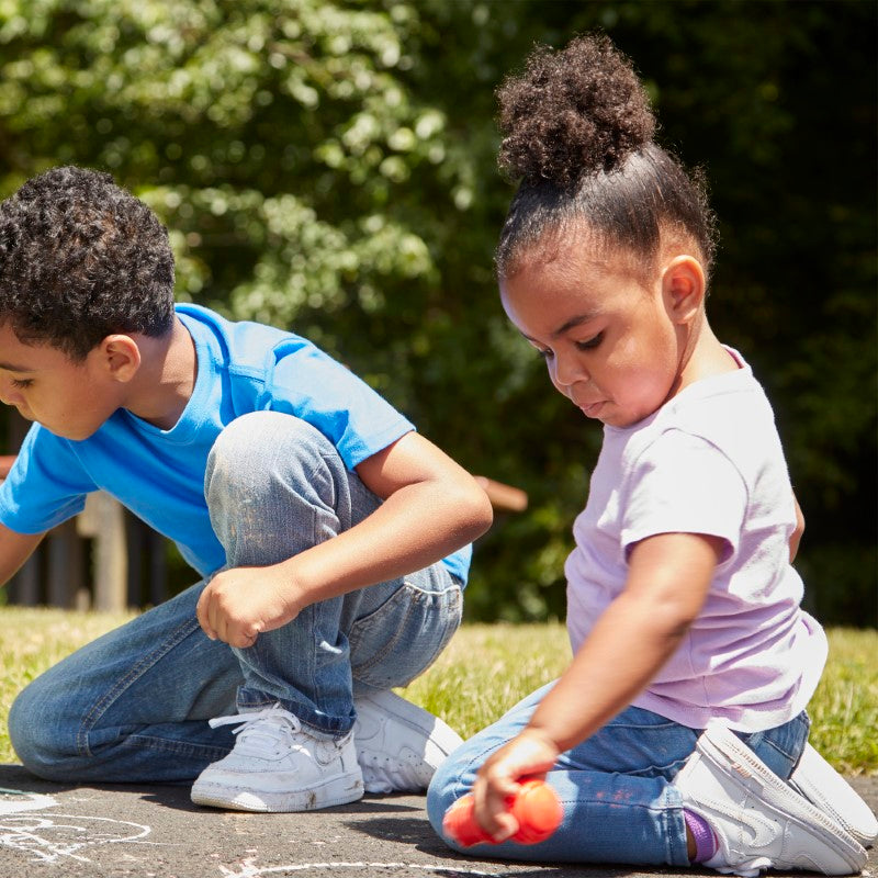 Colorful sidewalk chalk set for toddlers with adjustable holders, promoting creativity and fine motor skills.