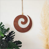 Rusted copper textured wall art featuring an intricate Koru design, symbolizing growth, measuring 300mm in diameter.