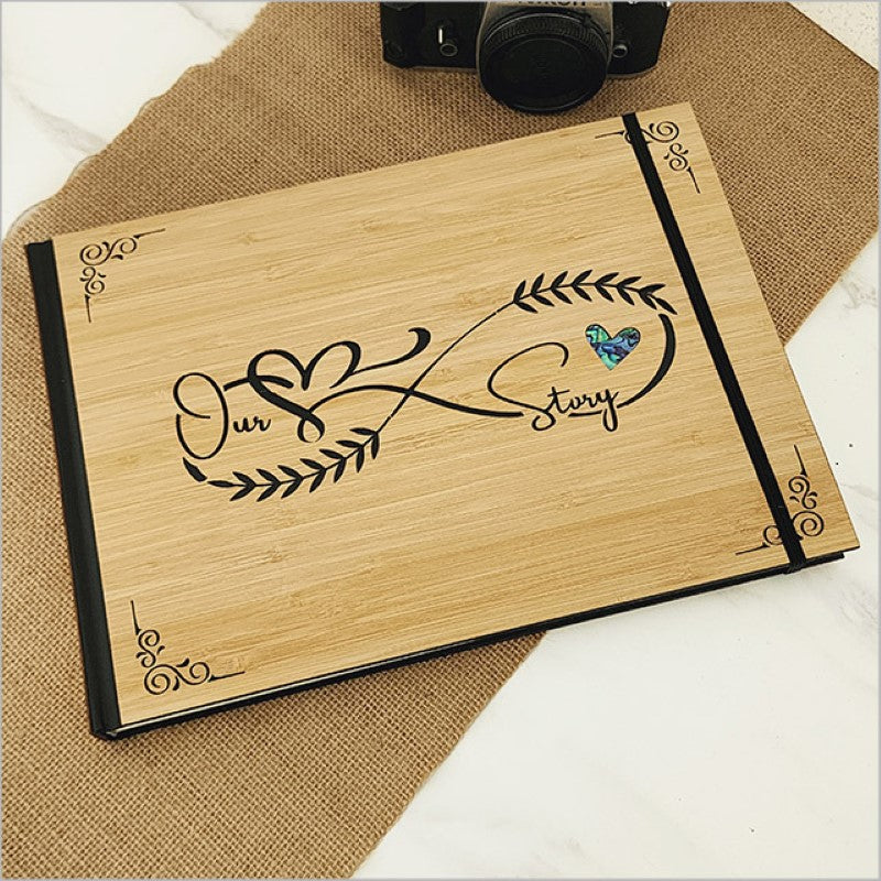 A small hardbound guest book journal made from eco-friendly bamboo, featuring Paua, with 128 acid-free pages for memories.