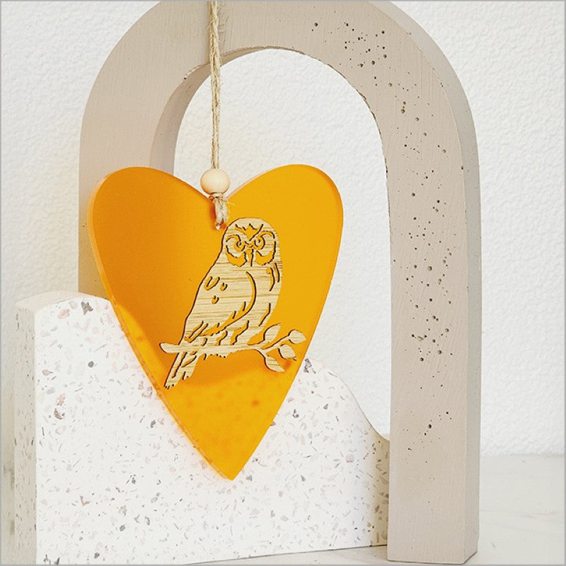 Heart-shaped orange satin acrylic ornament with laser-cut bamboo base, ready to hang for festive decor or gifting.