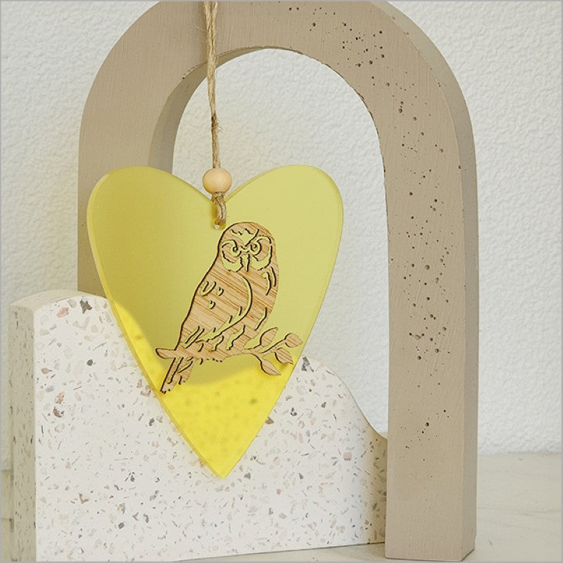 Heart-shaped hanging ornament in yellow satin acrylic, crafted from laser-cut bamboo, perfect for festive decor or gifting.