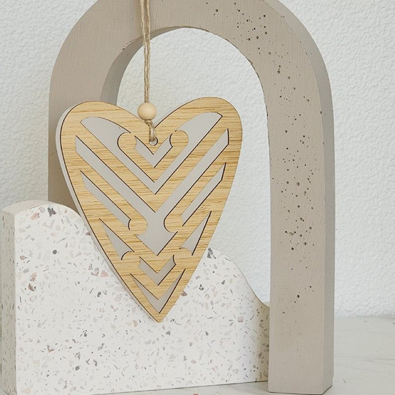 White satin acrylic heart ornament featuring intricate koru patterns, ideal for home decor or thoughtful gifts.