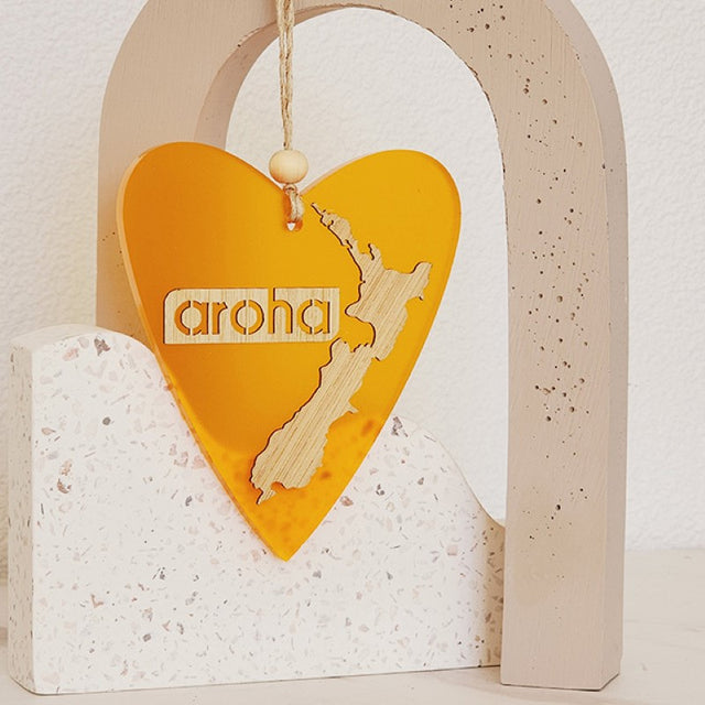 Heart-shaped orange satin acrylic hanging ornament, 90mm x 105mm, representing love and warmth for home decor.