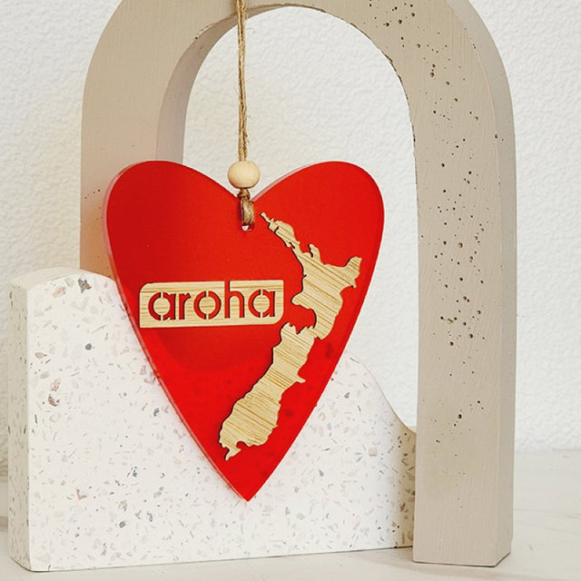 Hanging heart ornament in red satin acrylic, featuring a laser-cut design, perfect for gifting or home decor.
