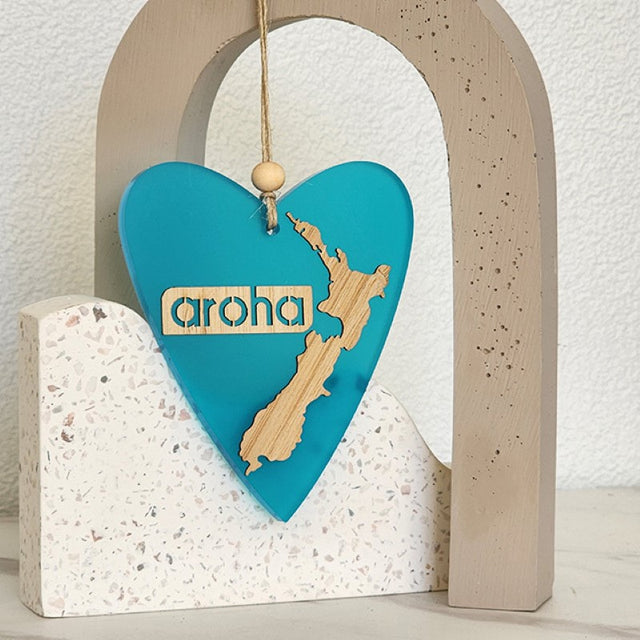Teal heart hanging ornament in satin acrylic, elegantly designed for home decor, symbolizes love and connection.