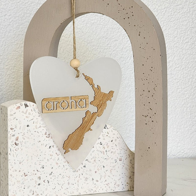 Heart-shaped white satin acrylic ornament featuring intricate laser-cut details, perfect for gifting and home decor.