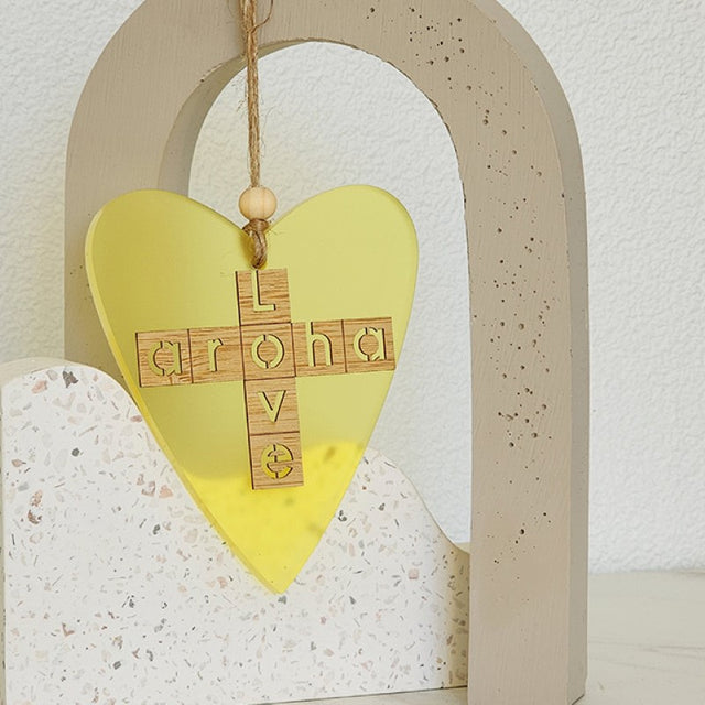Bright yellow heart ornament with bamboo backing, double-sided design, perfect for gifting and home decor.