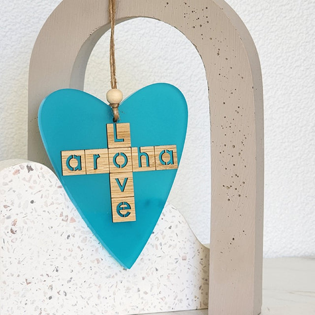 Teal satin acrylic heart ornament with laser-cut bamboo, symbolizing love; perfect for home decor or gifts.
