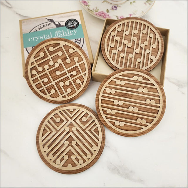 Coasters Set featuring bamboo and Rimu wood with an elegant koru design, perfect for decor and protecting surfaces.