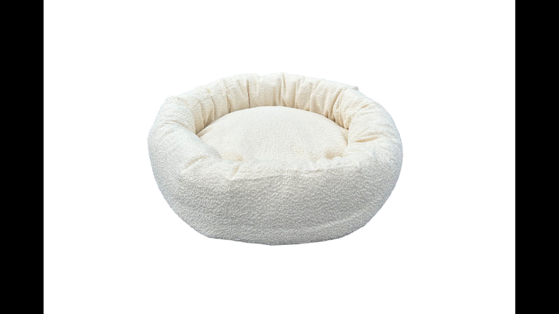 Round cream Boucle dog bed for small pets, 50cm diameter, offers plush comfort and stylish security for relaxation.