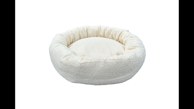 Cream round Boucle dog bed, 60cm, offers cozy comfort and elegant design for small breeds, with removable zip cover for easy cleaning.