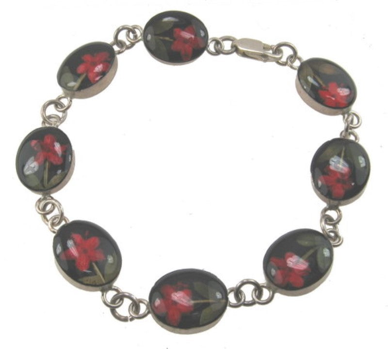 Sterling silver bracelet with a red flower design and elegant black accents, perfect for any occasion.