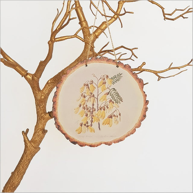 Wood slice wall art featuring vibrant yellow Kowhai flowers by Sarah Featon, ideal for enhancing any room's decor.