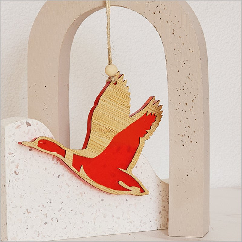 Vibrant red satin acrylic duck ornament, beautifully crafted with laser cut bamboo, perfect for holiday decorating and gifting.