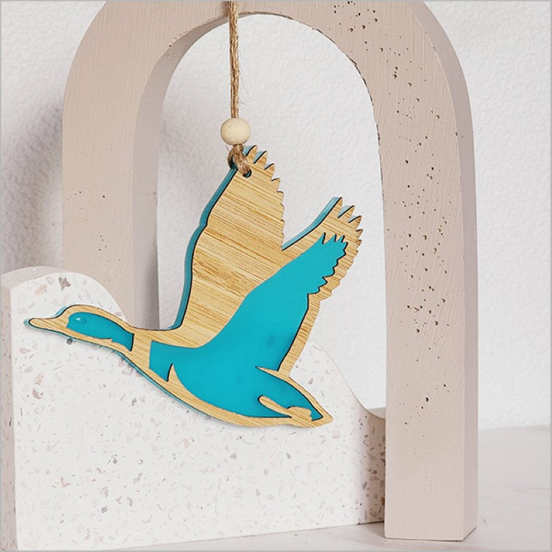 Teal satin acrylic duck ornament with intricate laser-cut designs, perfect for vibrant home decor and easy display.