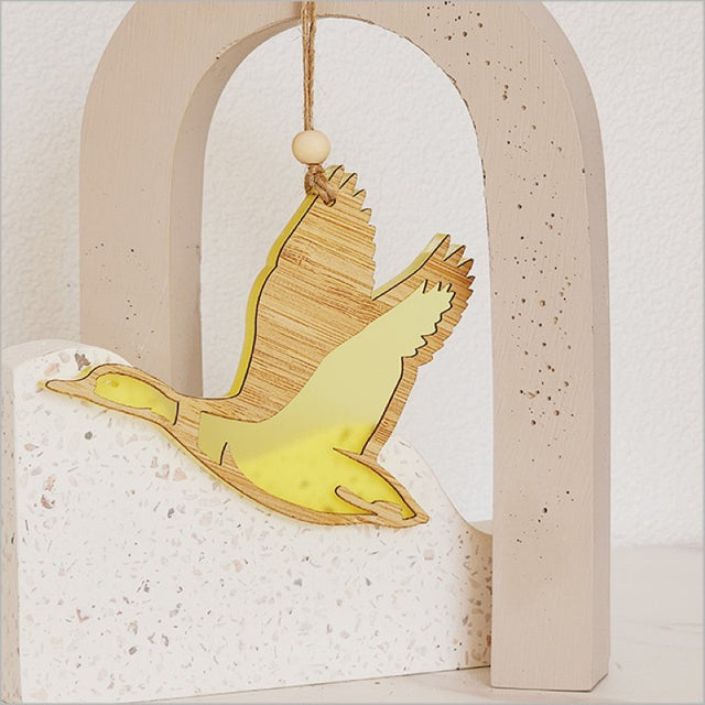Decorative yellow satin acrylic duck ornament, perfect for kids' rooms and cheerful seasonal displays.