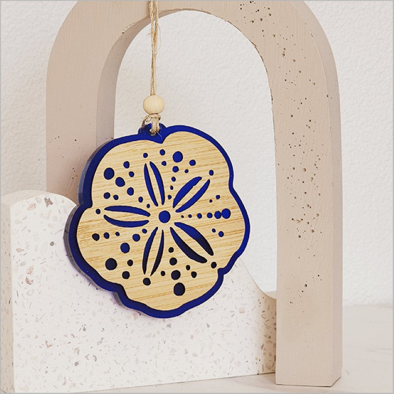 Blue satin acrylic hanging ornament shaped like Kina, featuring laser-cut bamboo design, perfect for home decor and gifting.