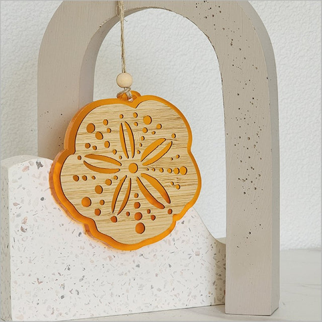 Vibrant orange acrylic hanging ornament, laser cut with a unique design, ready to elevate your holiday decor.