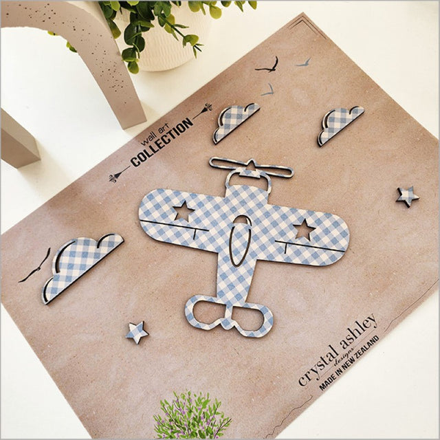 Whimsical wall art set featuring a textured propeller plane, fluffy clouds, and stars, perfect for nursery decor.