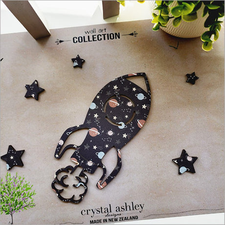 Textured wall art featuring a rocket and six stars, perfect for children's nursery or bedroom decor.