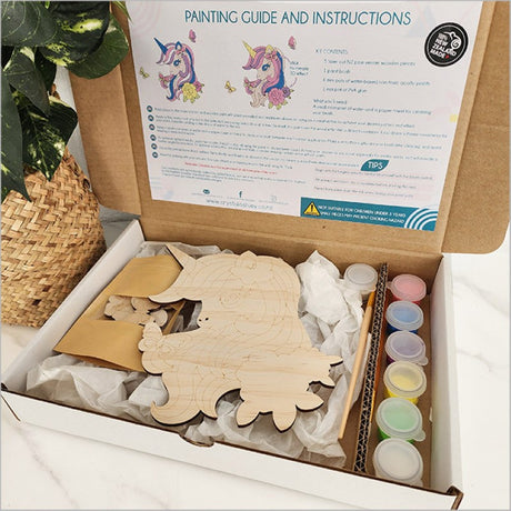 Pine DIY Paint Kit featuring a half-body unicorn, complete with paints, brush, and instructions for creative fun.