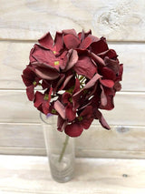 Vibrant red artificial hydrangea stem with a dry look, perfect for adding color and rustic charm to home decor.