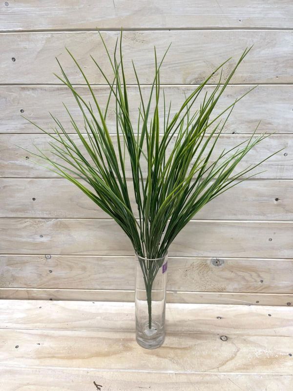 Vibrant green artificial grass bush with long needles, perfect for stylish indoor/outdoor decor without maintenance.