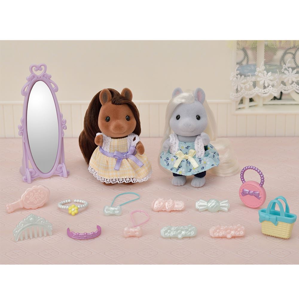 Two pony girl figures, Bella and Giselle, with accessories for imaginative play and styling fun in a charming set.