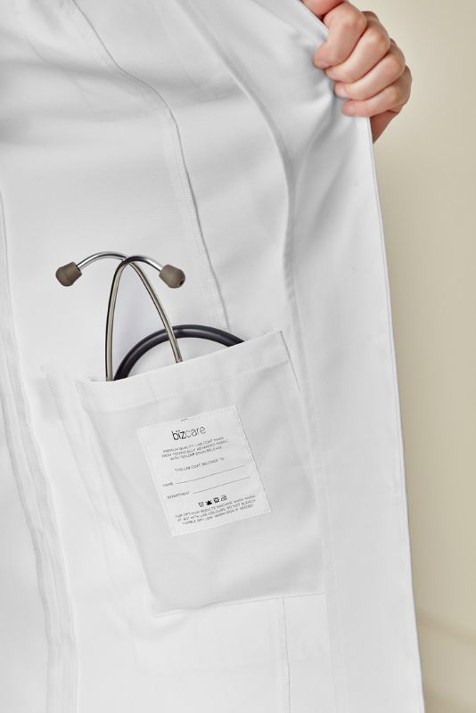 Women's long line white lab coat with tailored fit, multiple pockets, and Teflon® stain release technology for comfort and style.