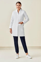 Women's stylish white long line lab coat with tailored fit, Teflon-treated fabric, multiple pockets, and headphone wire slot.