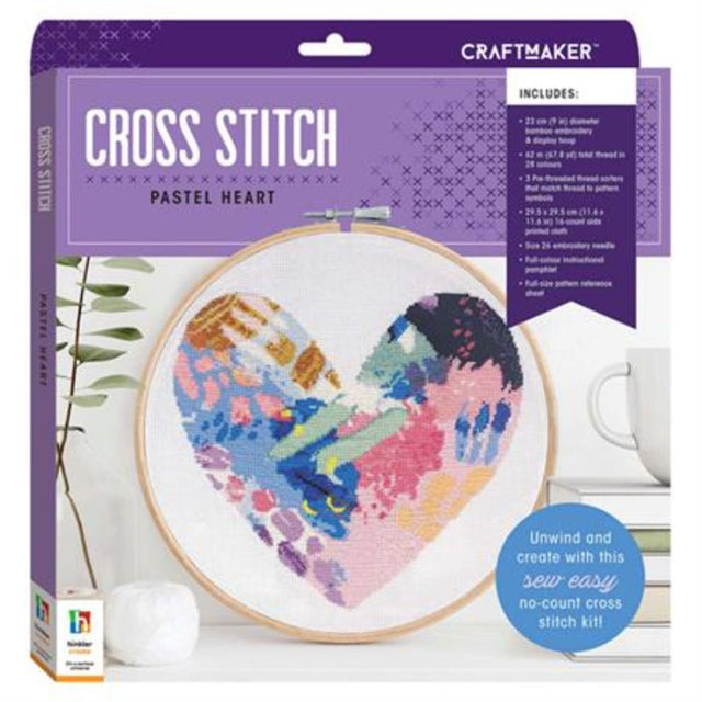 Pastel heart cross stitch kit with bamboo hoop, vibrant threads, Aida cloth, and instructional pamphlet for crafting enthusiasts.