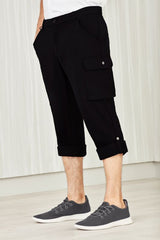 Men's black cargo pants with comfort waist, multiple pockets, and roll-up legs for versatility and ease in various settings.