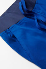 Electric Blue jogger scrub pants with antibacterial stretch panels, navy waistband, and stylish knit hem cuff, tailored for comfort.