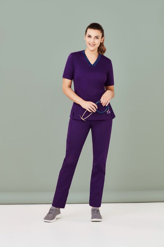 Women's Riley Straight Leg Scrub Pant in vibrant purple, featuring a comfy navy knit waistband and soft, breathable fabric.