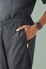 Stylish women's charcoal scrub pants in size 3XL with antibacterial fabric, elastic waistband, and cargo pockets.